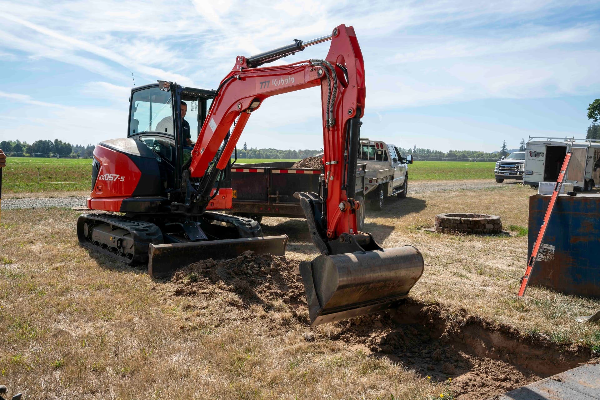 Heavy equipment operator at a construction site representing the manufacturers and trades businesses we serve